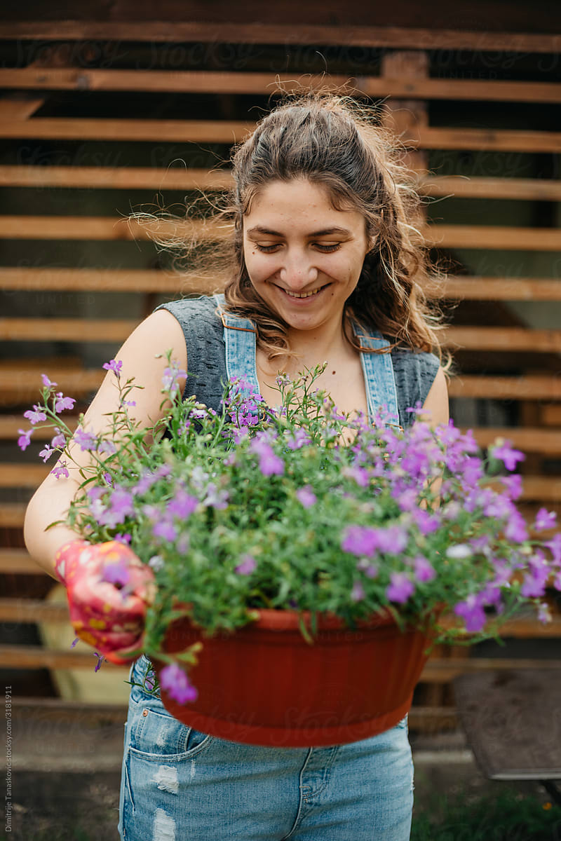 Smiling Woman With Flower Pot.
