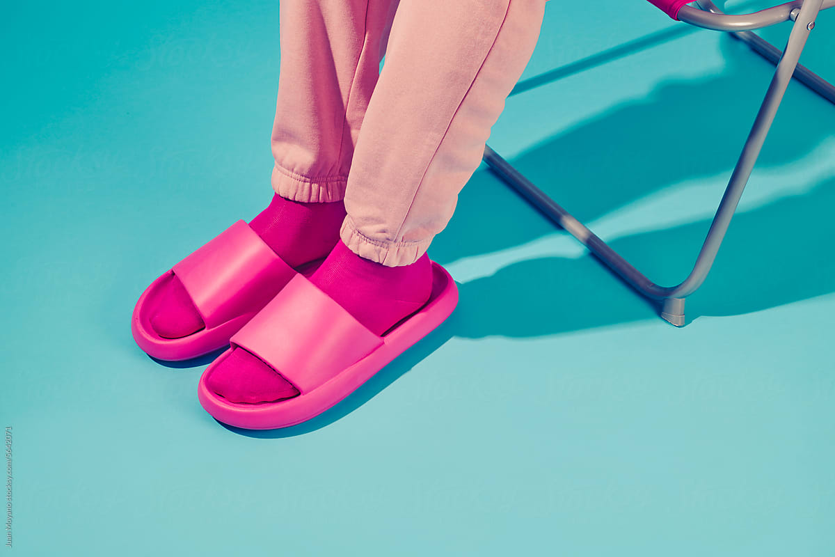man sitting in a folding chair wearing pink socks and sandals