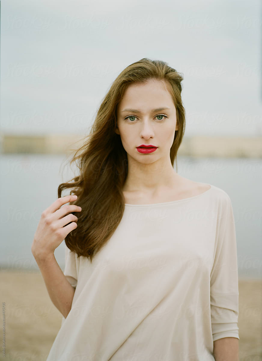 Portrait Of The Beautiful Woman With Red Lips Looking At Camera By Stocksy Contributor Amor