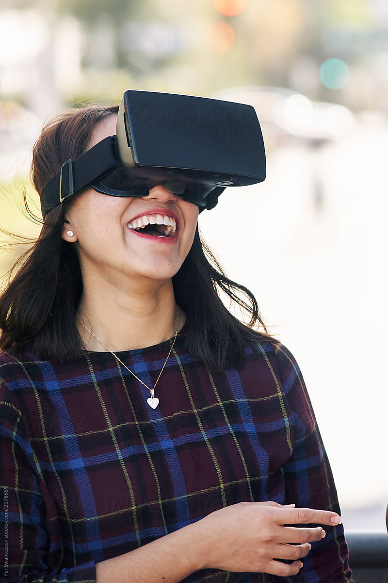 Young attractive woman with a VR headset