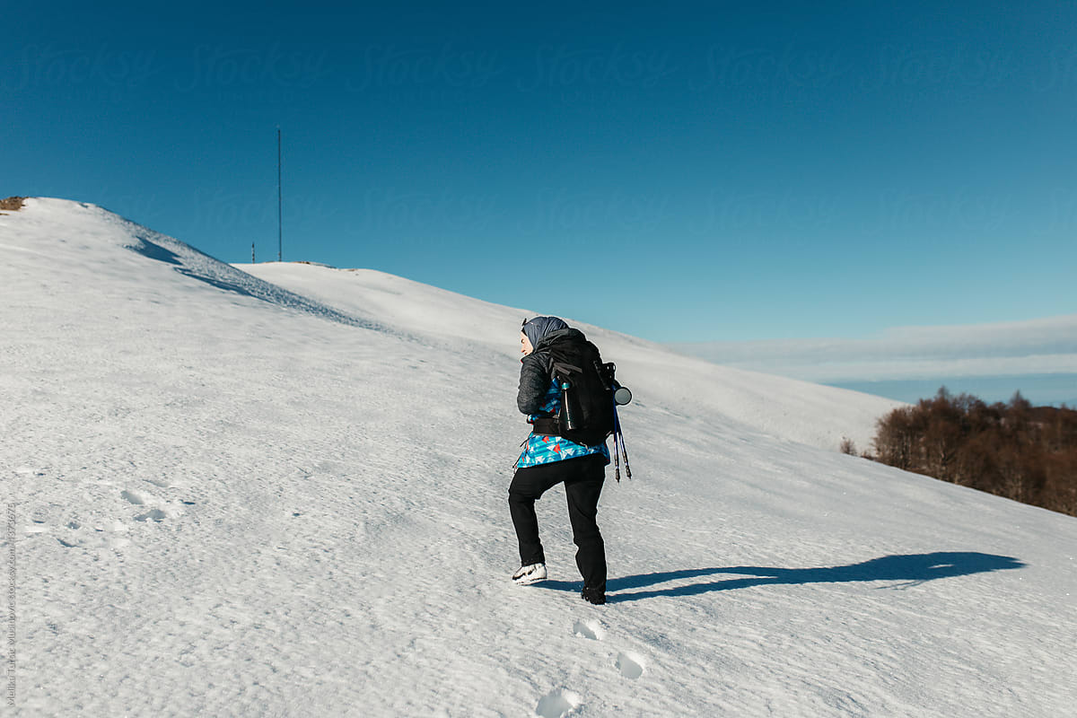 Female hiker in snow cover mountain