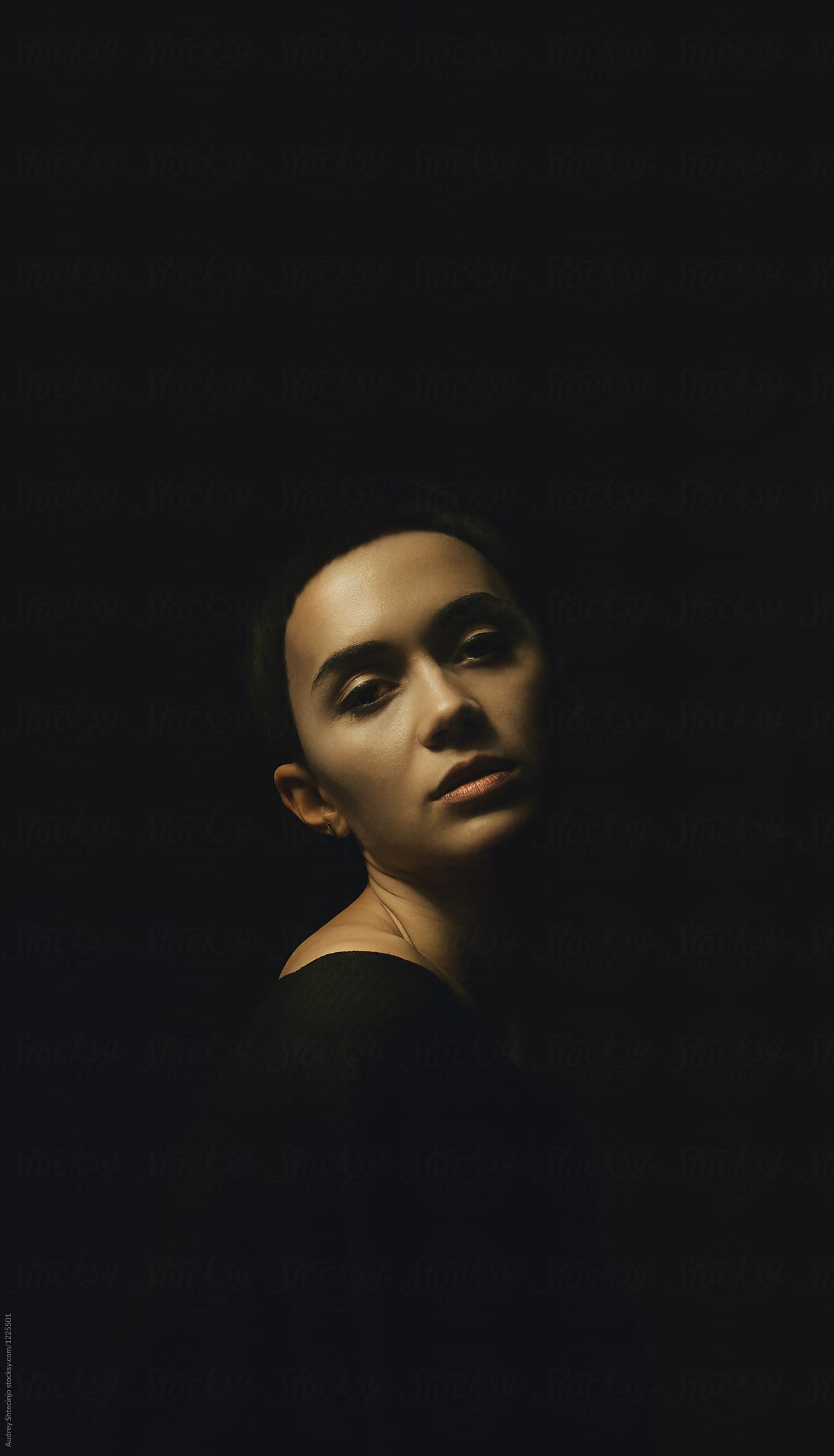 Dark/calm portrait of young woman with dark short hair