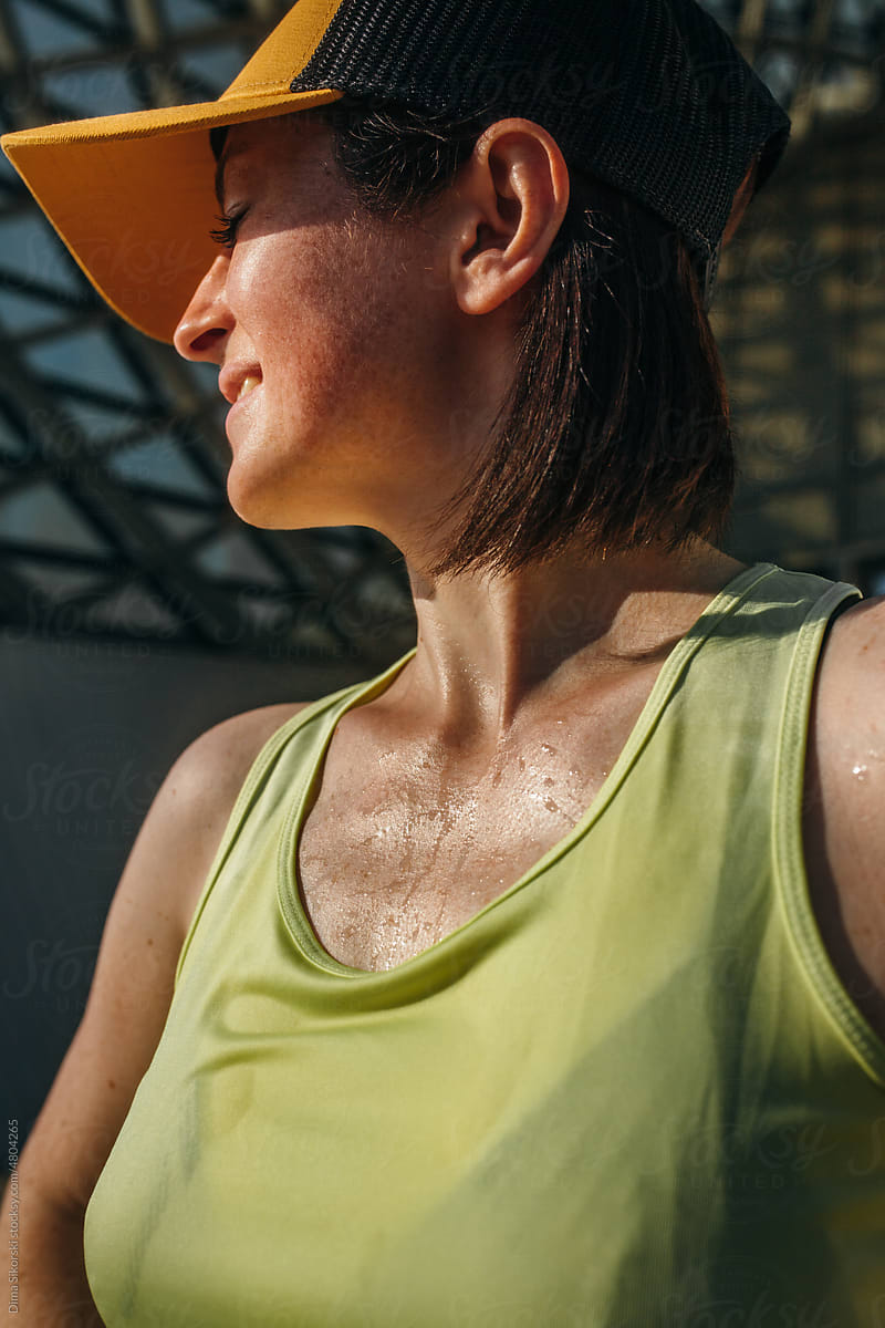 Tired of fitness wet girl in sportswear on a hot day close-up