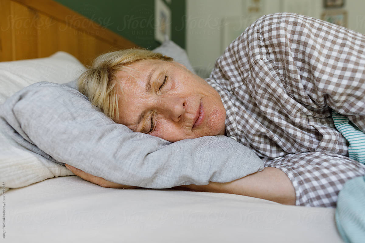 A sleeping senior woman in the bed