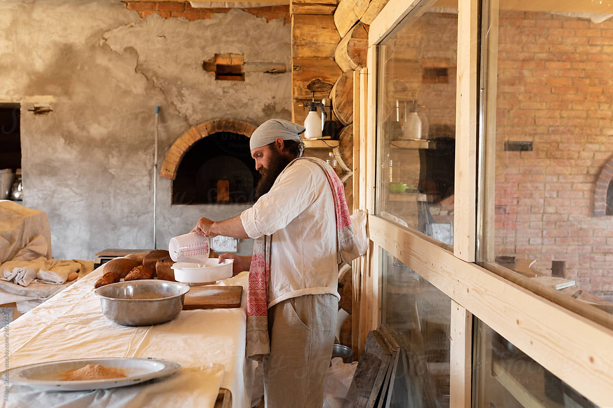 Man preparing dough in rural bakery house
