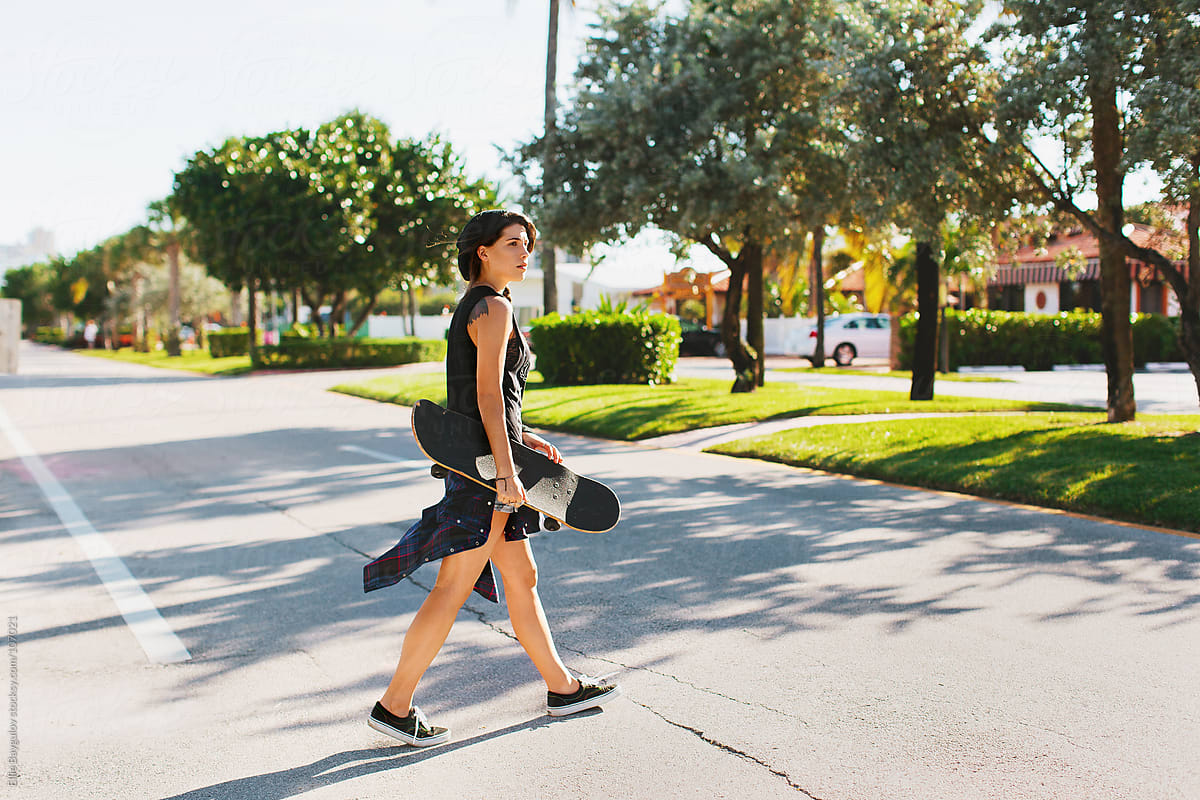 Skater Girl Walking Across The Street By Ellie Baygulov Stocksy United