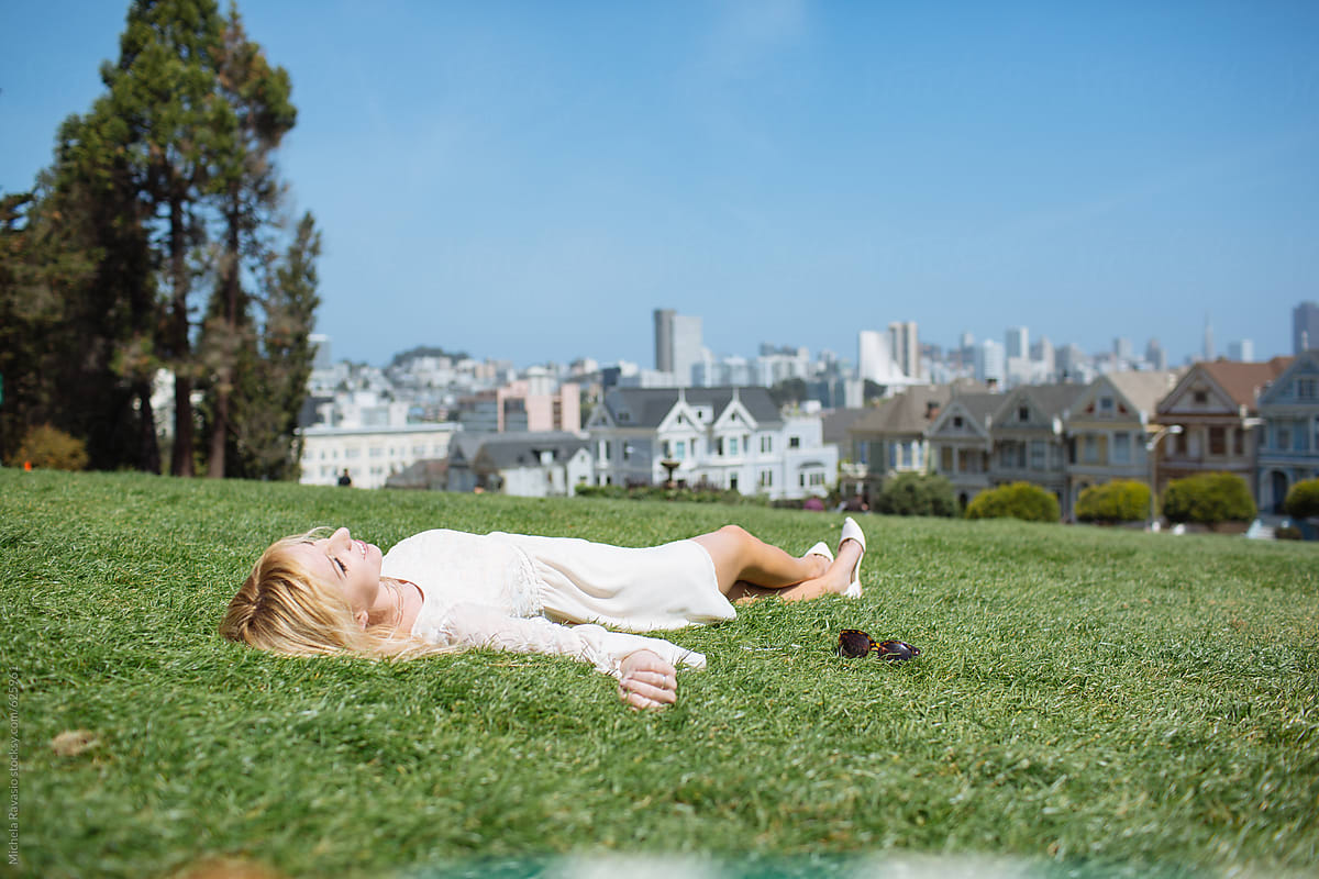 Relaxed Woman Lying On The Grass By Stocksy Contributor Michela