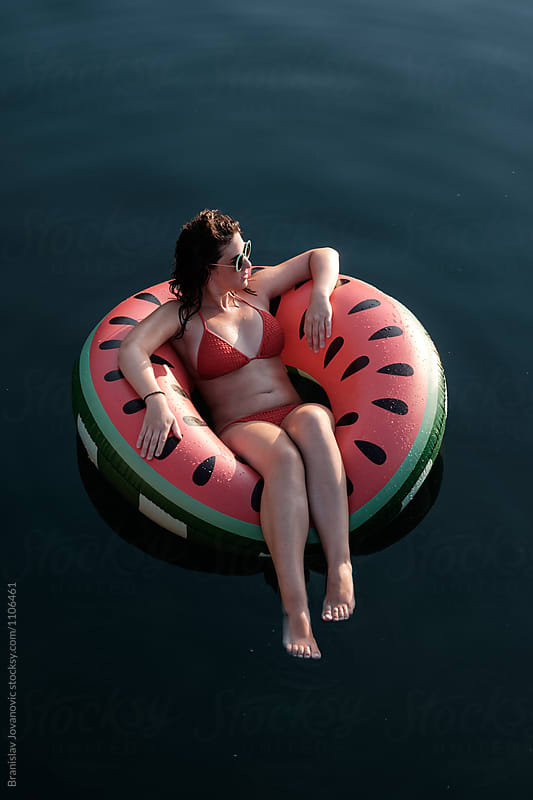 Woman in Bikini Floating on Inflatable Watermelon Tube in the Sea