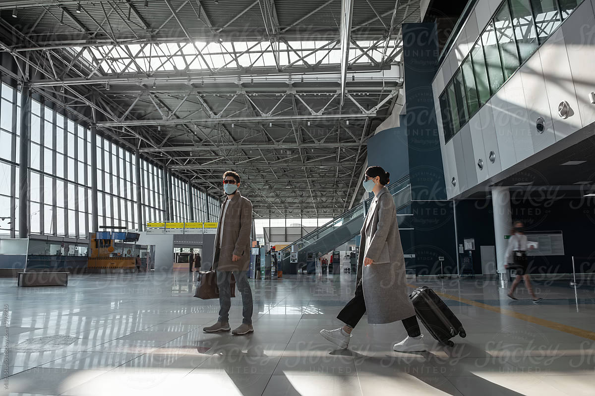 Travelers in modern airport terminal during epidemic