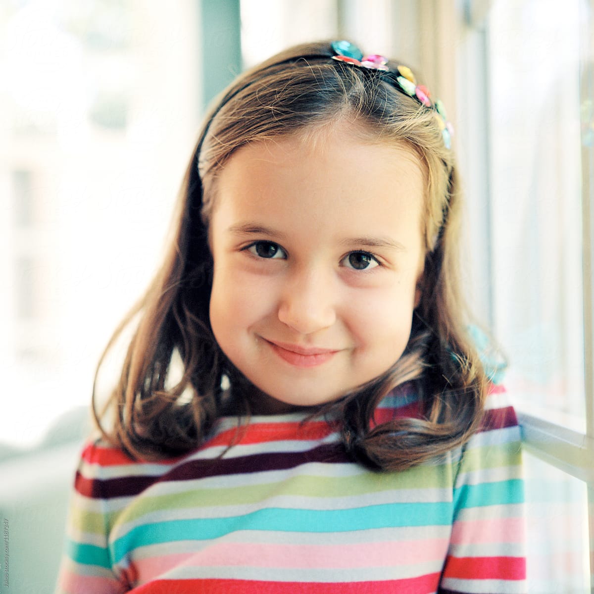 Portrait Of A Cute Young Girl In A Striped Sweater Del Colaborador De Stocksy Jakob 