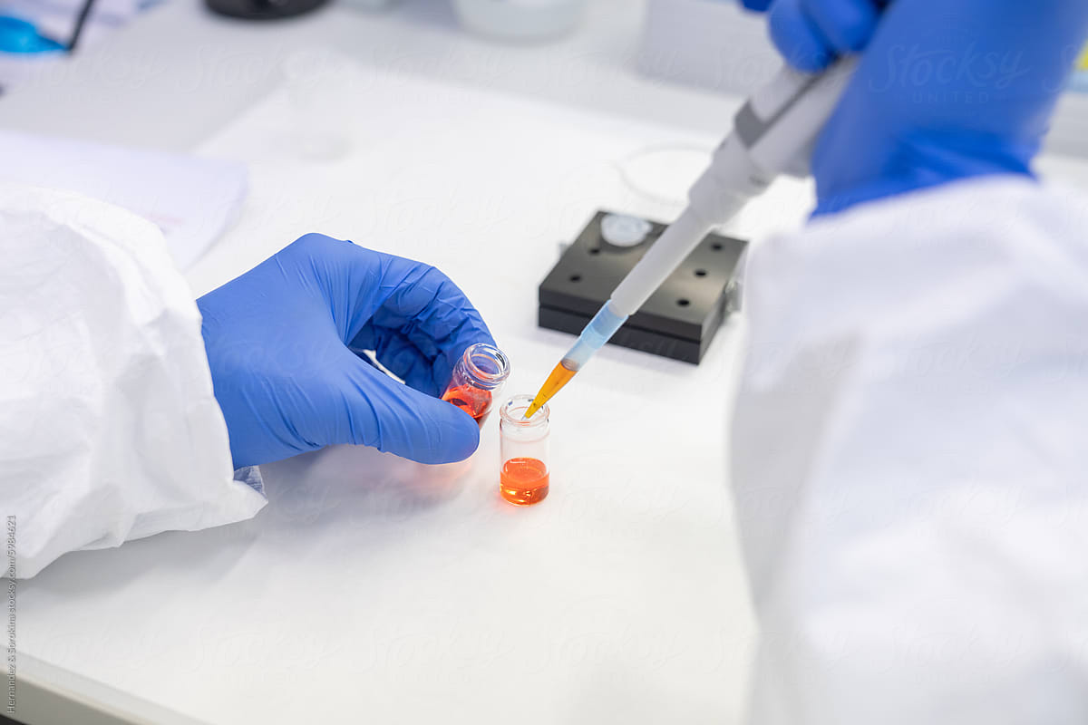 Anonymous Researcher Working In Lab Using Pipette