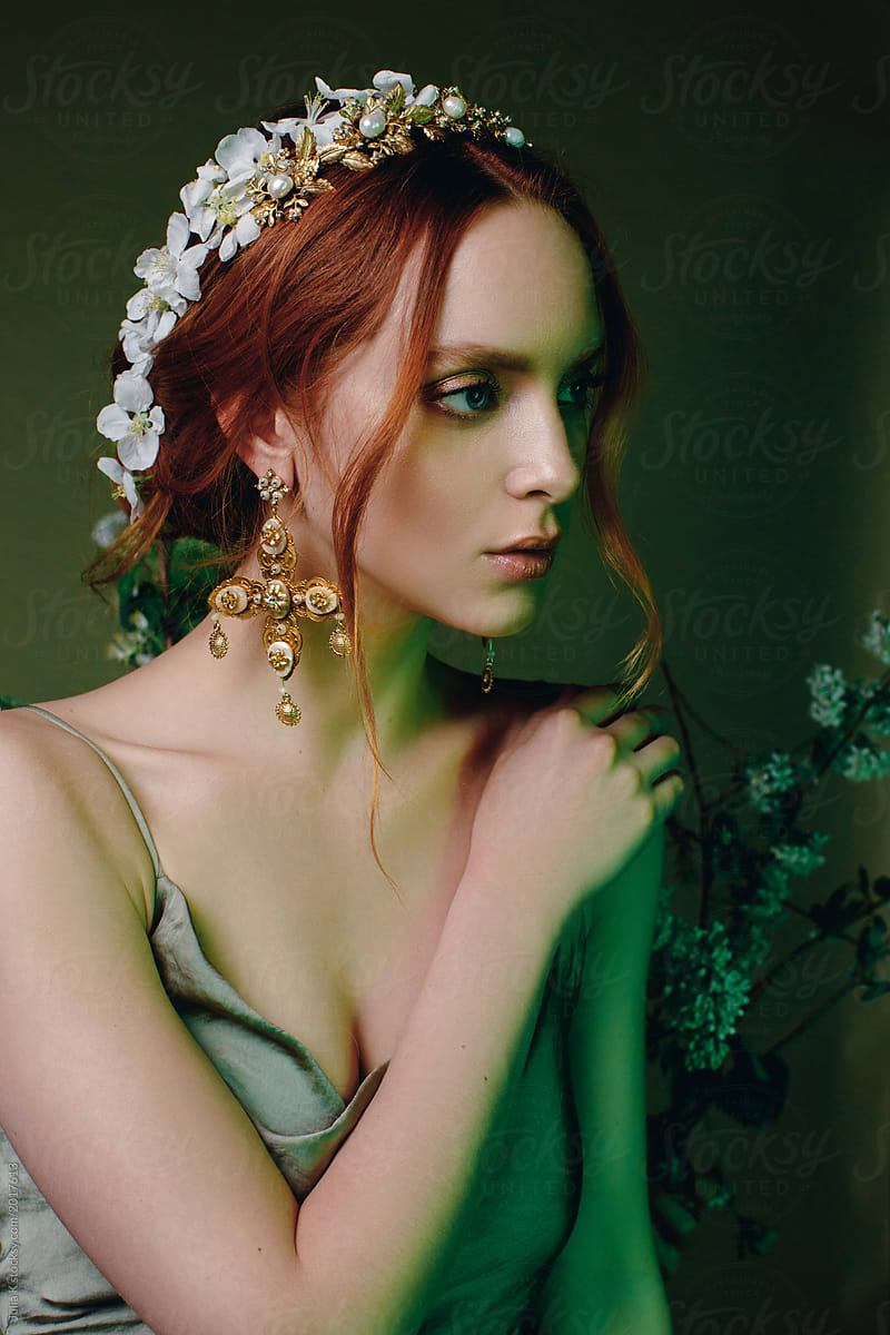 Portrait of a red headed young woman wearing jewelery