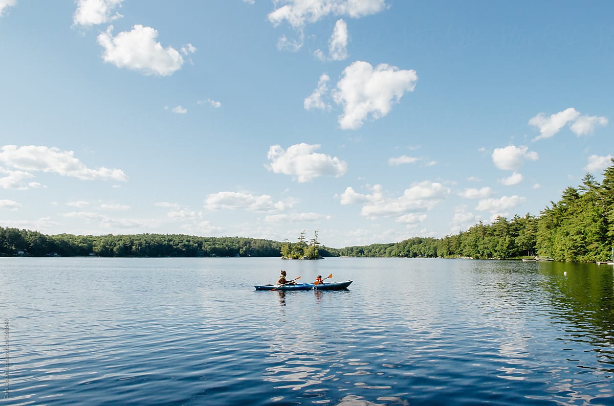 Father and son kayak together on a lake