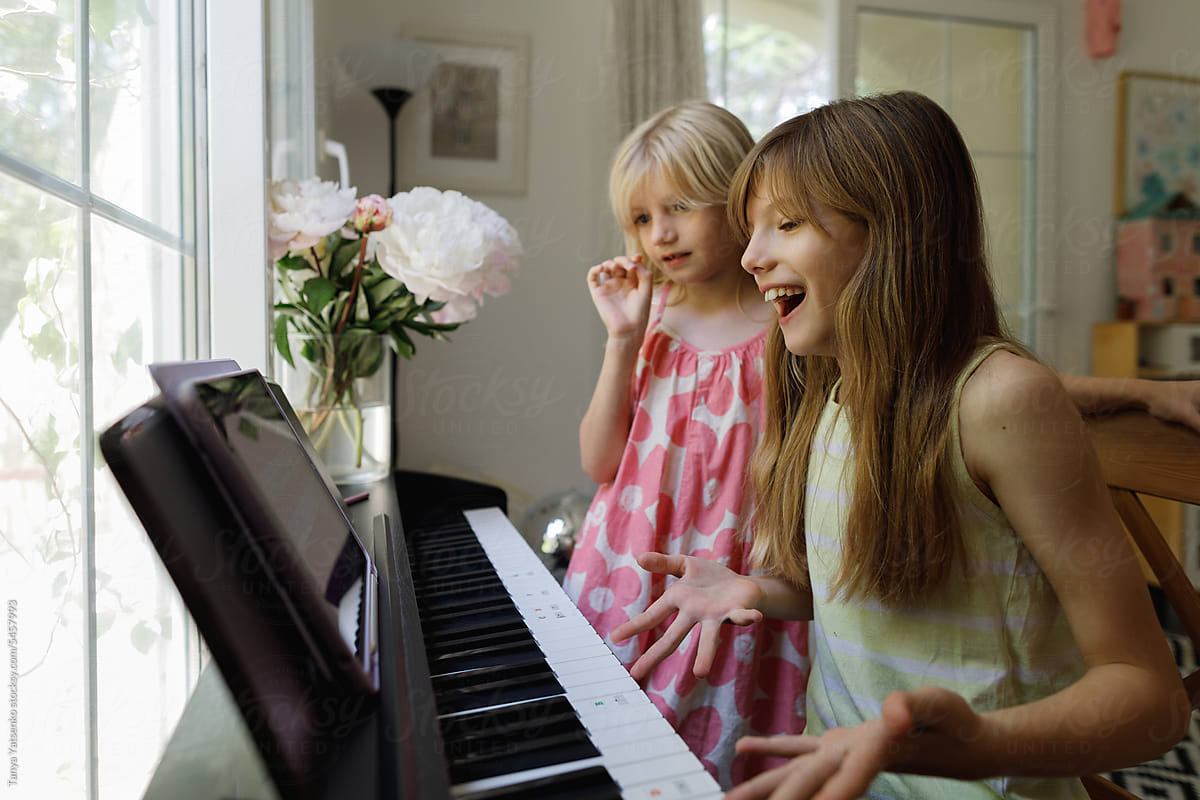Girl playing the piano at home
