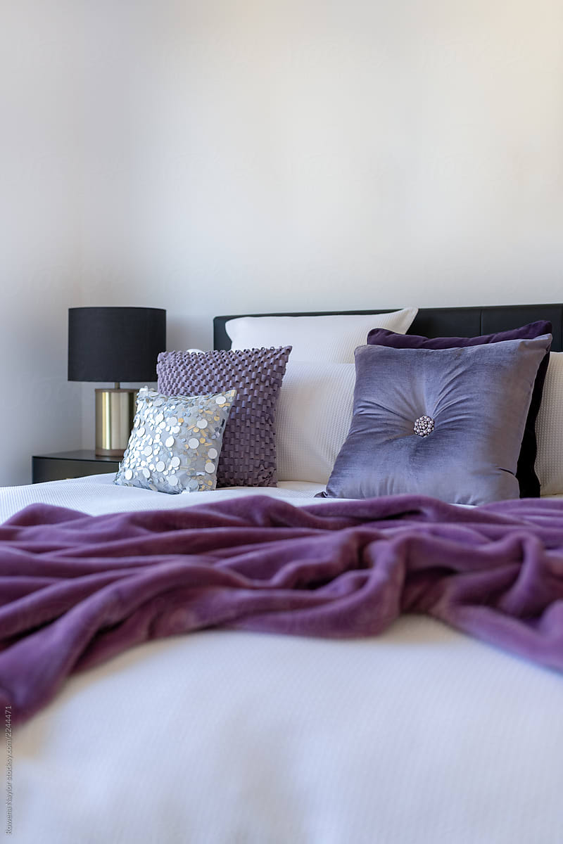 Styled bedroom with purple accent