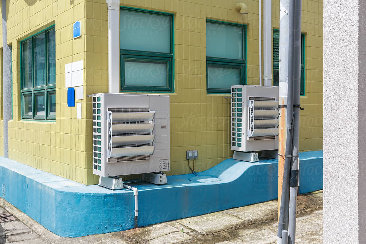 Ventilation system installed on khaki building wall.