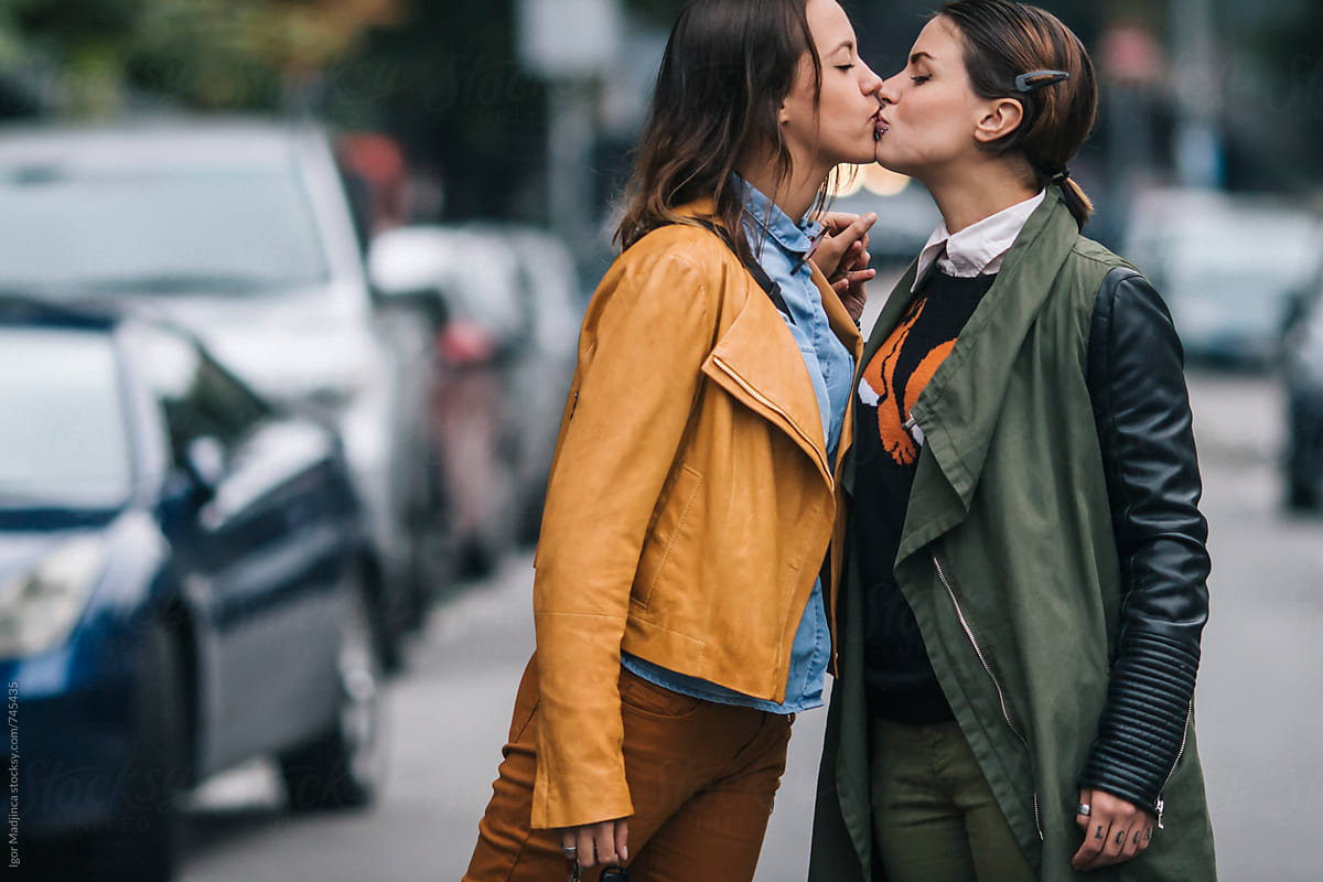 Two Colorfully Dressed Girls In Love Kissing On The Street Lesbian By Stocksy Contributor