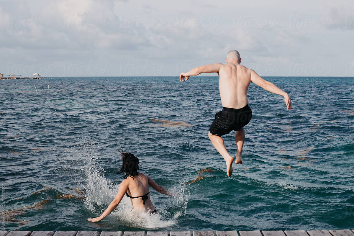 Couple Jumping into the Ocean
