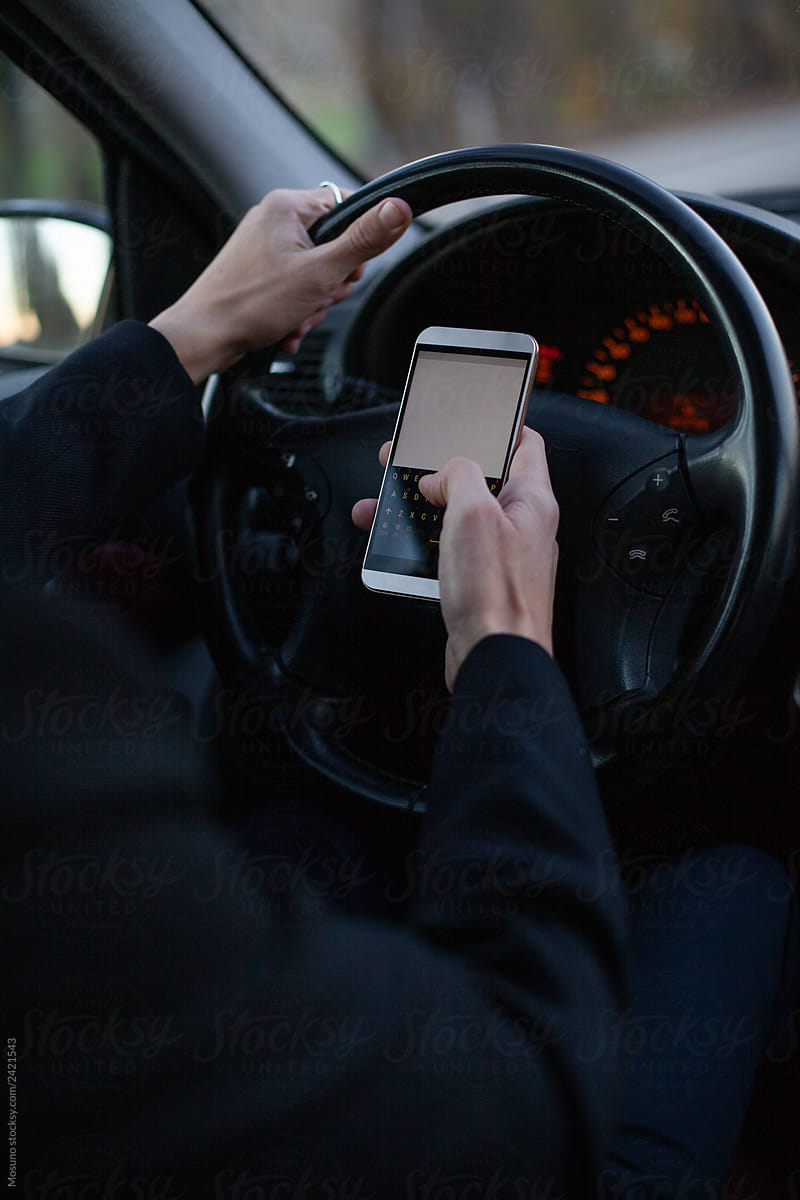 Man using a smartphone in the car