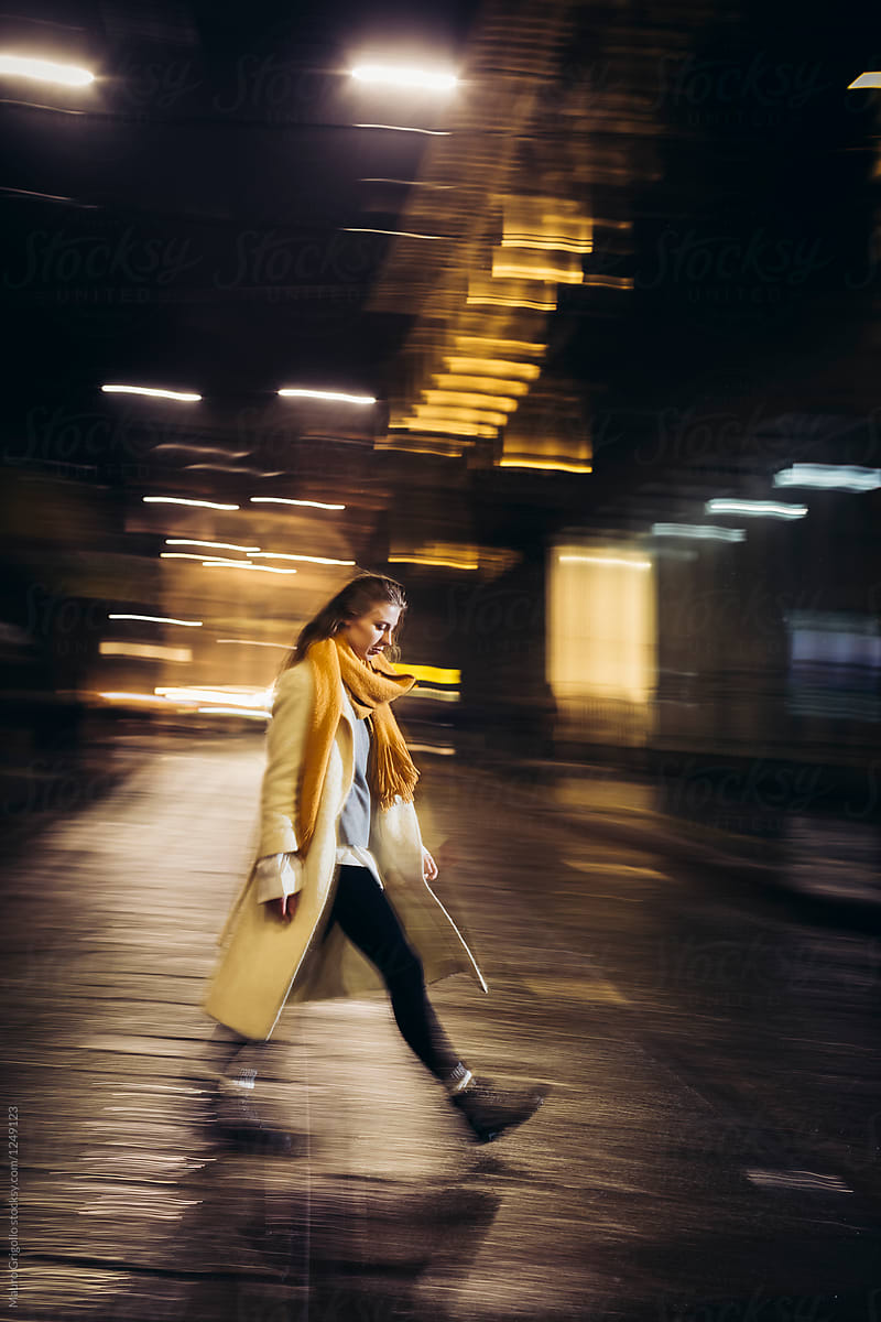 Woman walks alone in the city at night