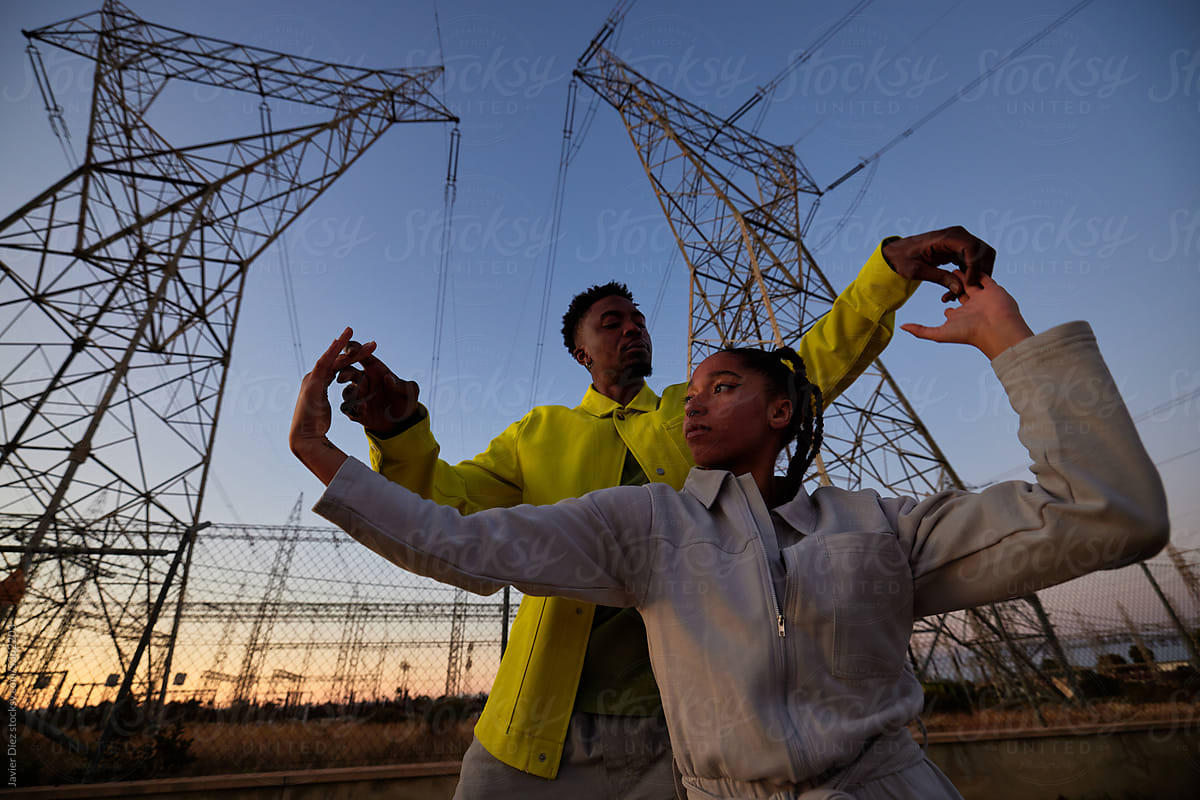Cool  man and woman against transmission towers