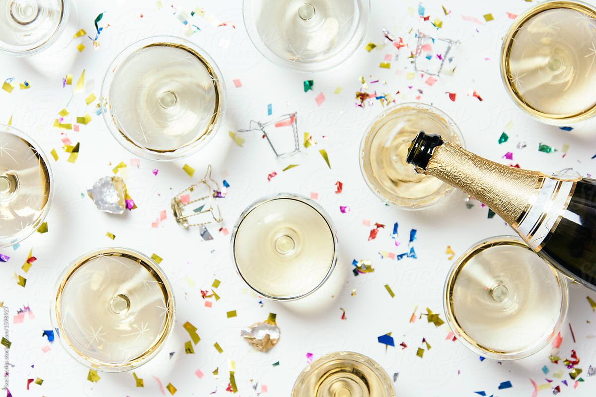 Champagne glasses and confetti New Year party table