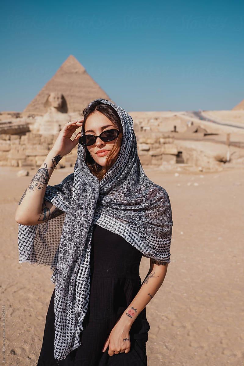 Tourist woman visiting the great sphinx and the pyramids of giza