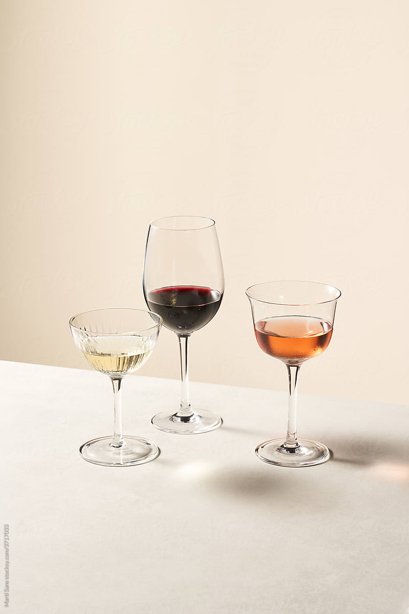 Crystal wineglasses with assorted wine on table