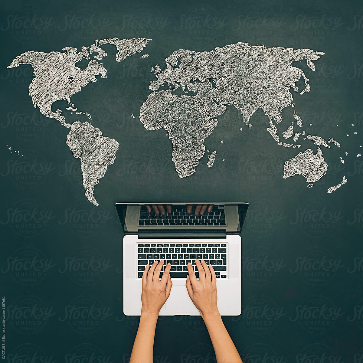 Internet search with notebook. World map on chalkboard.