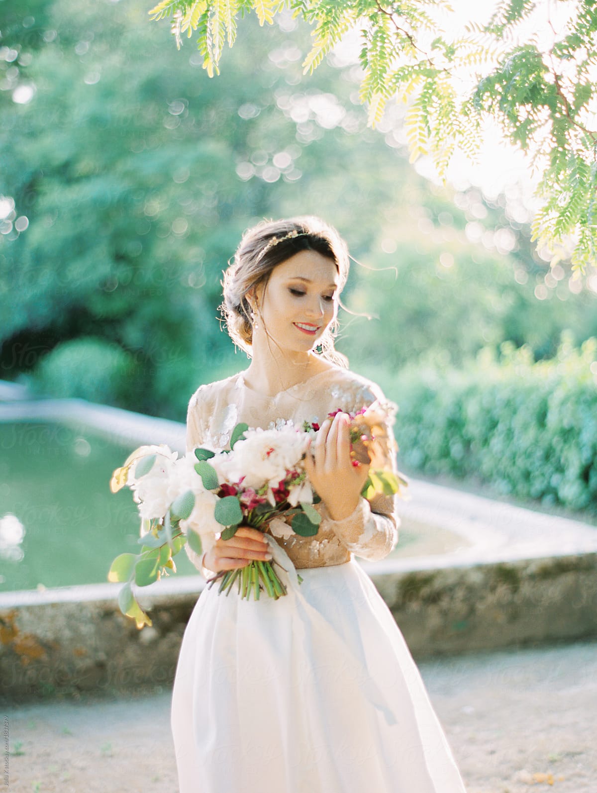 Young bride with bunch of flowers
