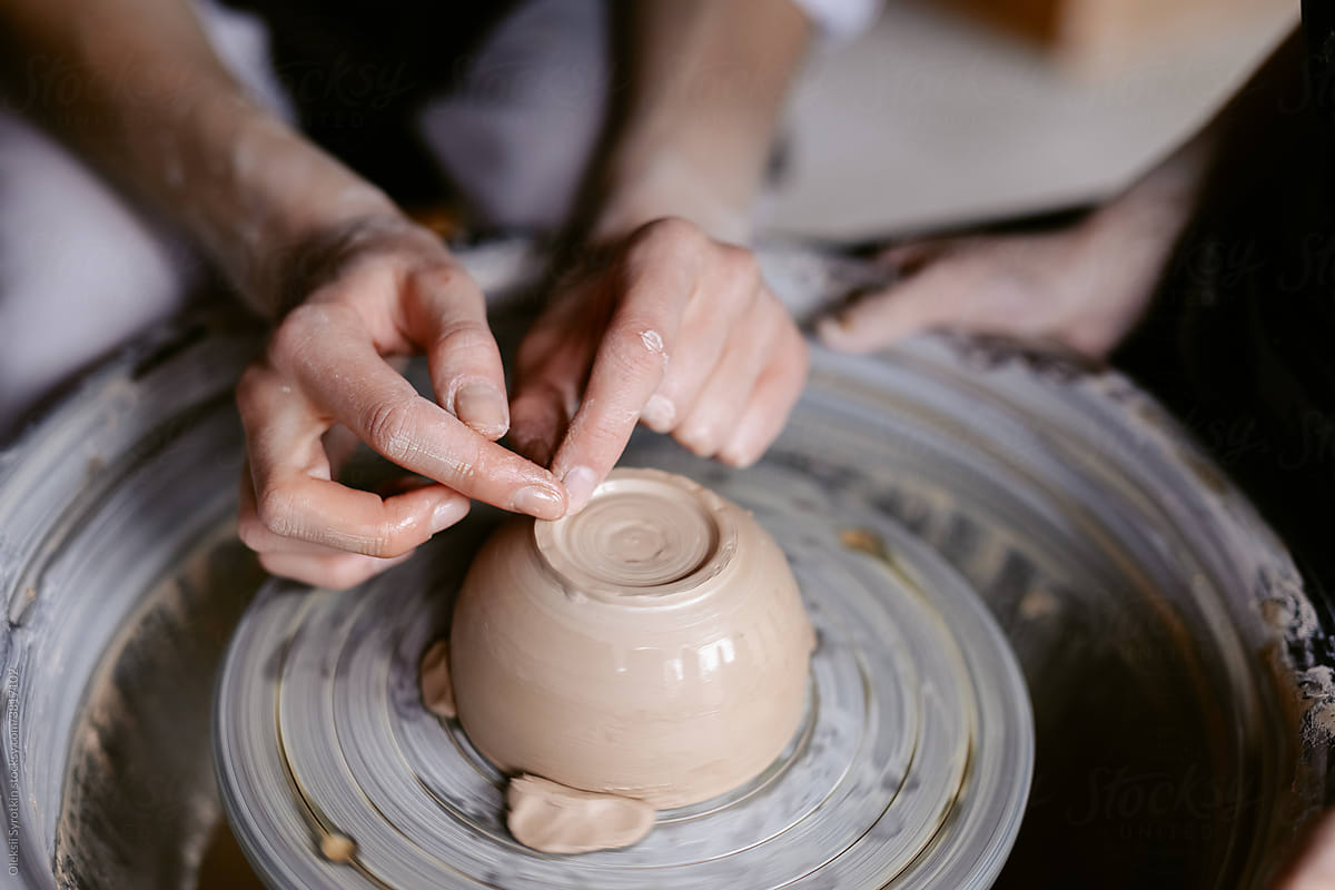 Artist finishing creating pinch pot