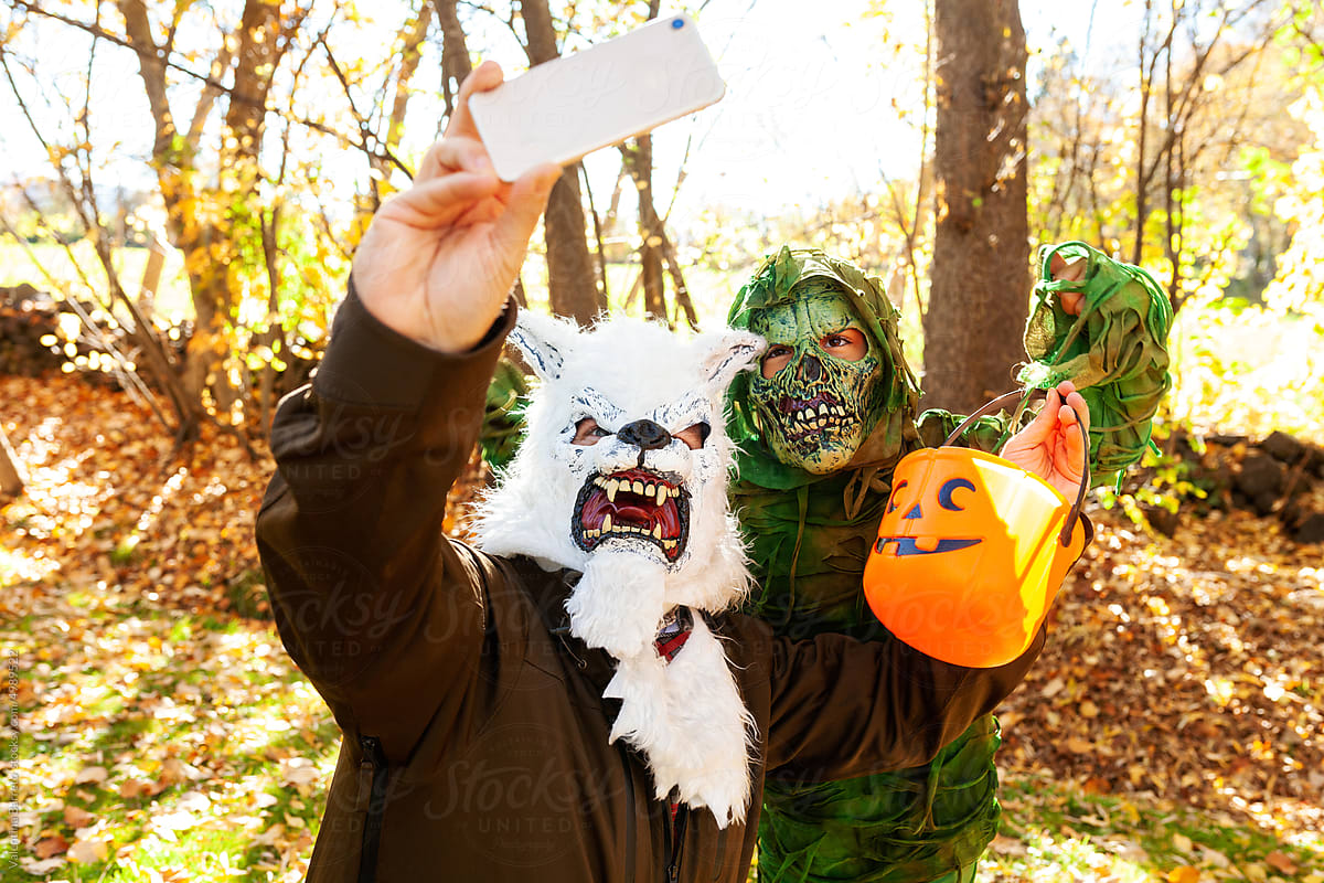 Father and son disguised on Halloween taking selfies