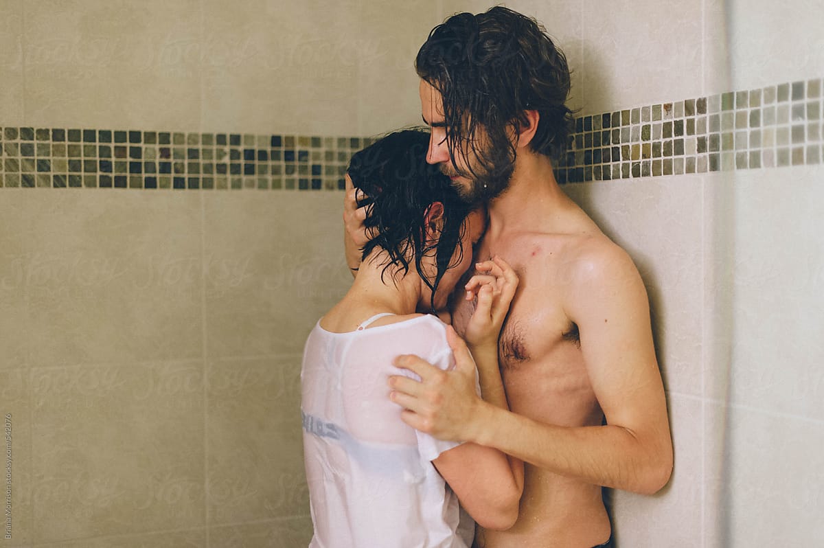 Passionate Couple Standing in a Shower Holding Each Other