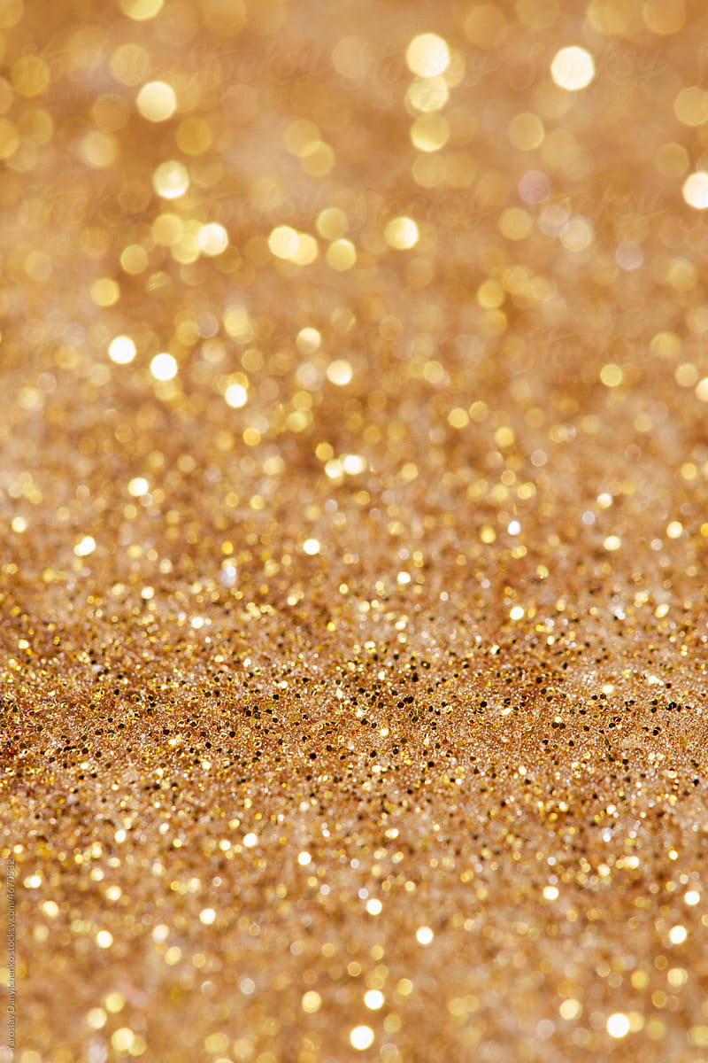 Background of golden sand with shiny grains
