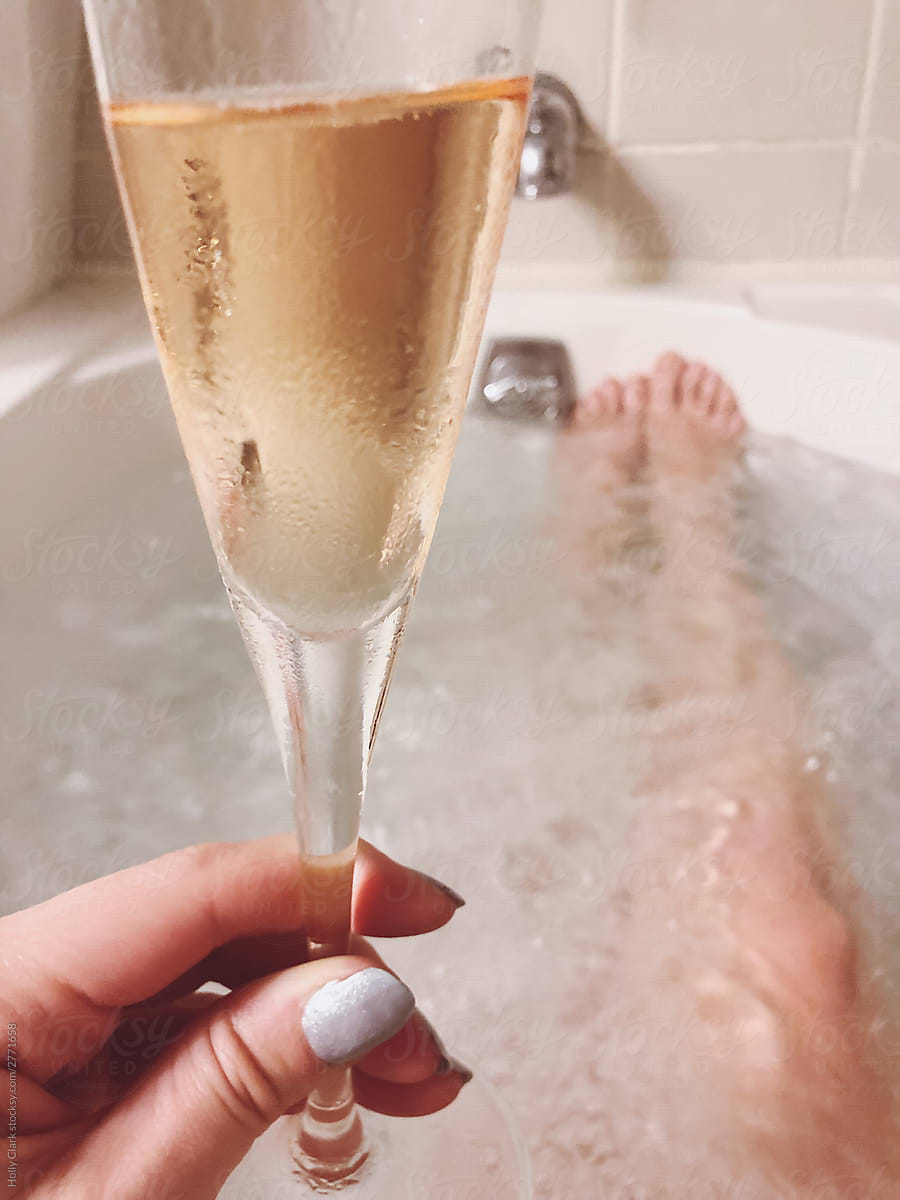 Woman S Hand Holding Champagne Flute While Taking Bath Del Colaborador De Stocksy Holly Clark