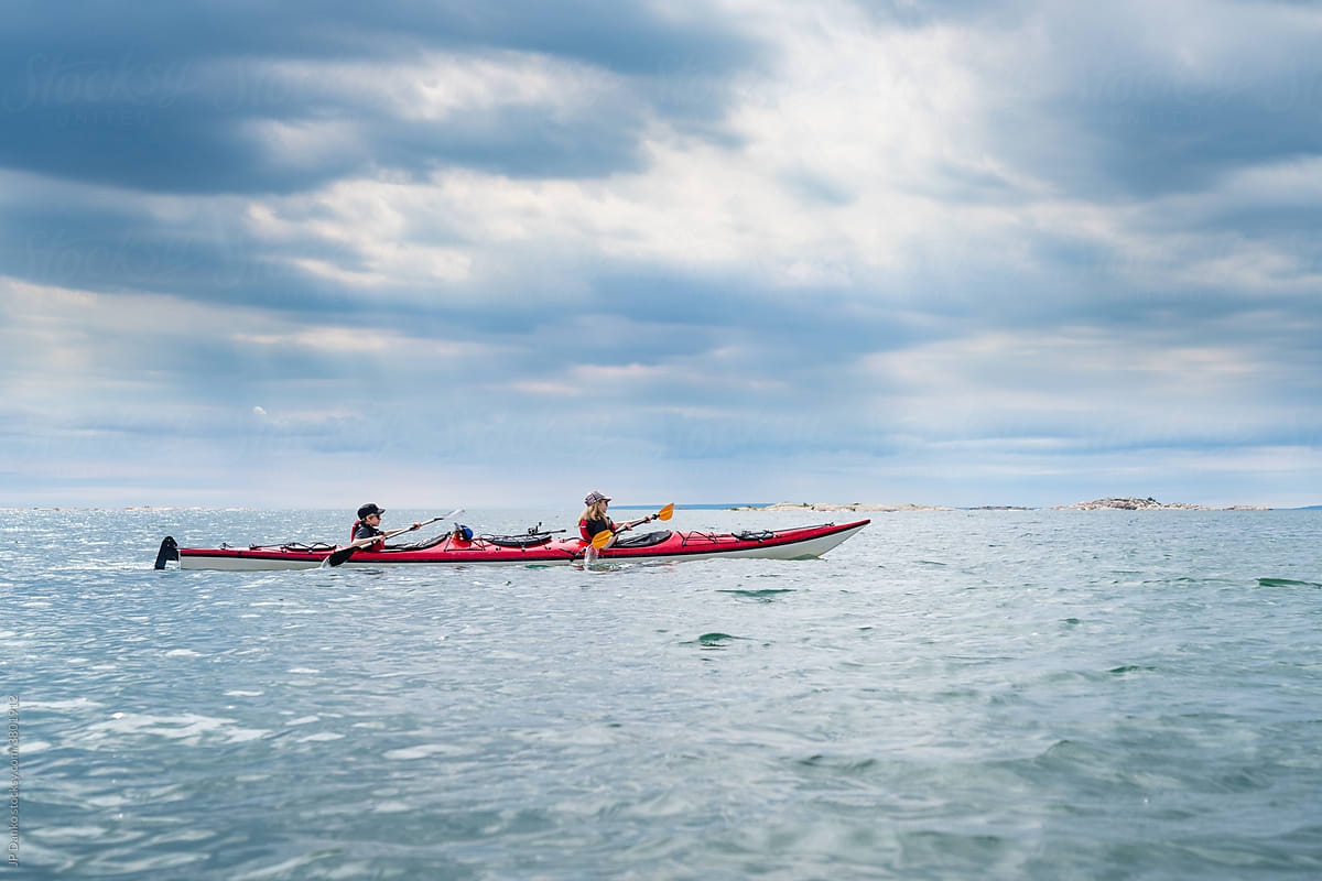 Teens Paddling Tandem Sea Kayak on Georgian Bay Killarney Ontario Canada