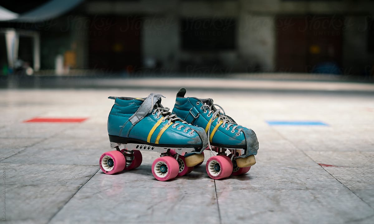 Roller derby roller skates sitting on a track ready to go