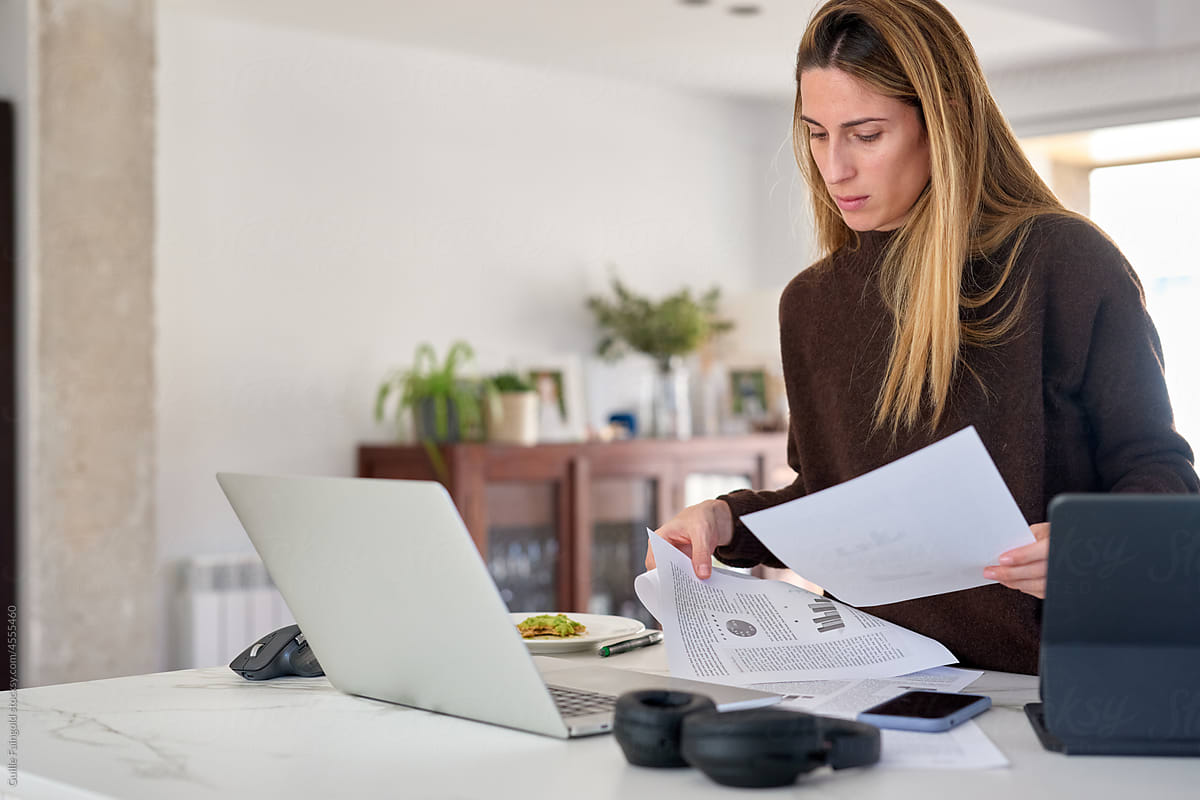 Businesswoman sorting papers on table