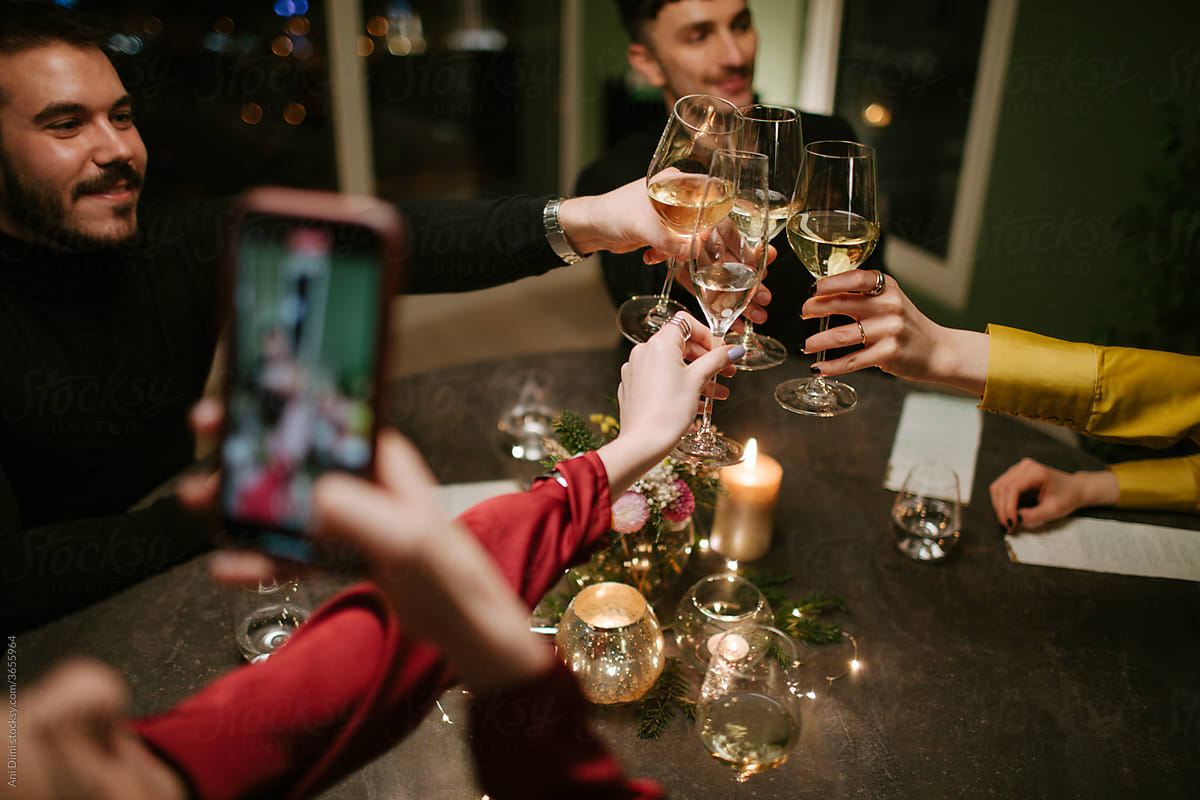 Friends Toasting During An Indoor Dinner Party
