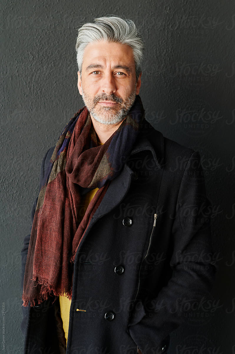 Mature man wearing a scarf and jacket
