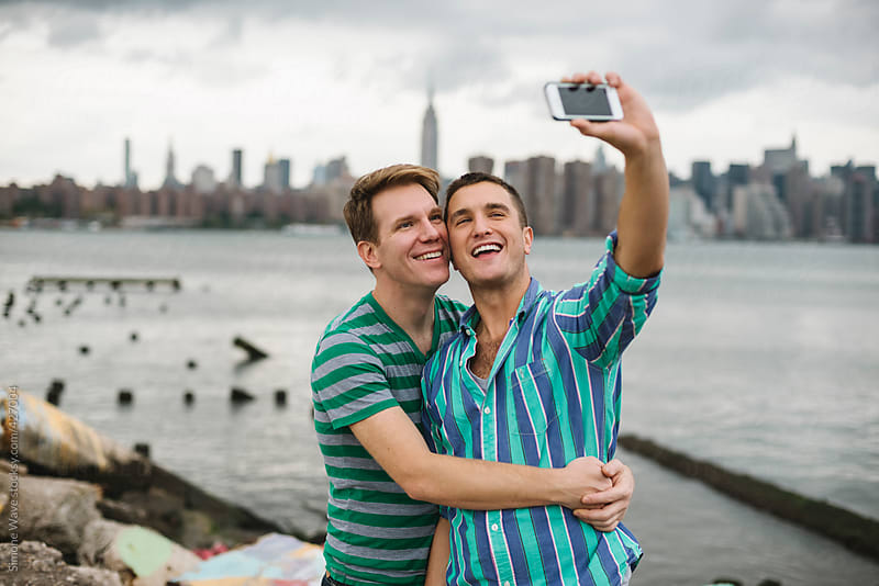 Gay Couple Taking A Selfie Against Manhattan Skyline By