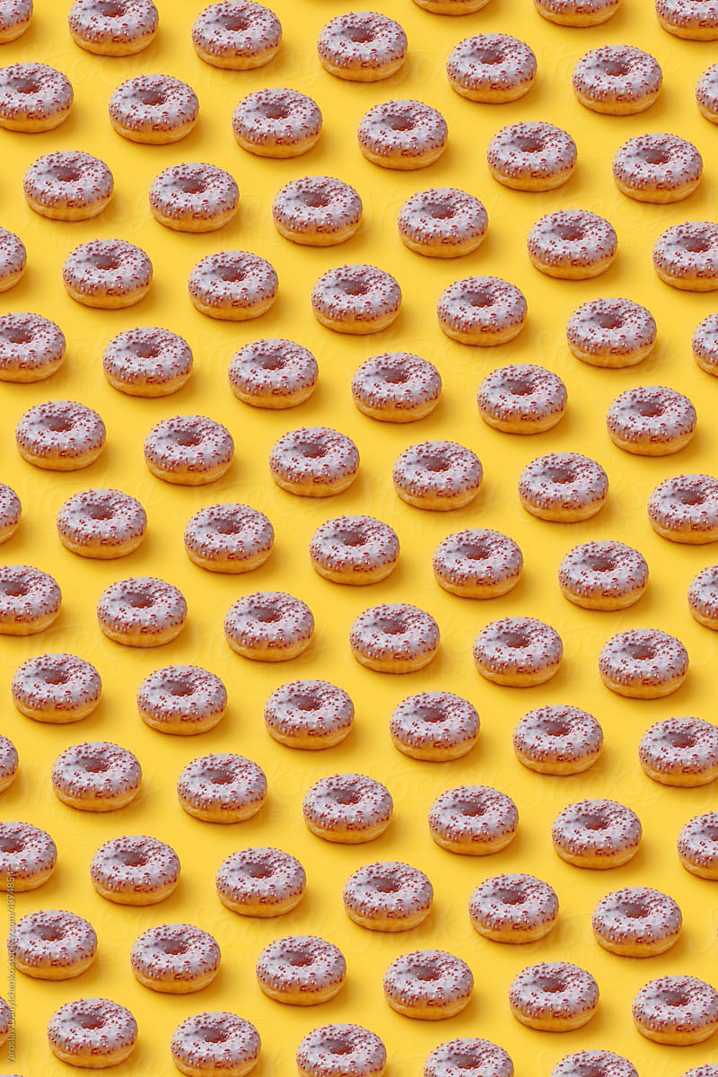 Pattern of glazed donuts with sprinkles