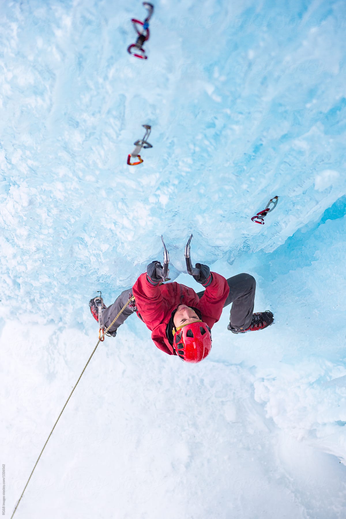 Female climber on steep icefall folowing the route