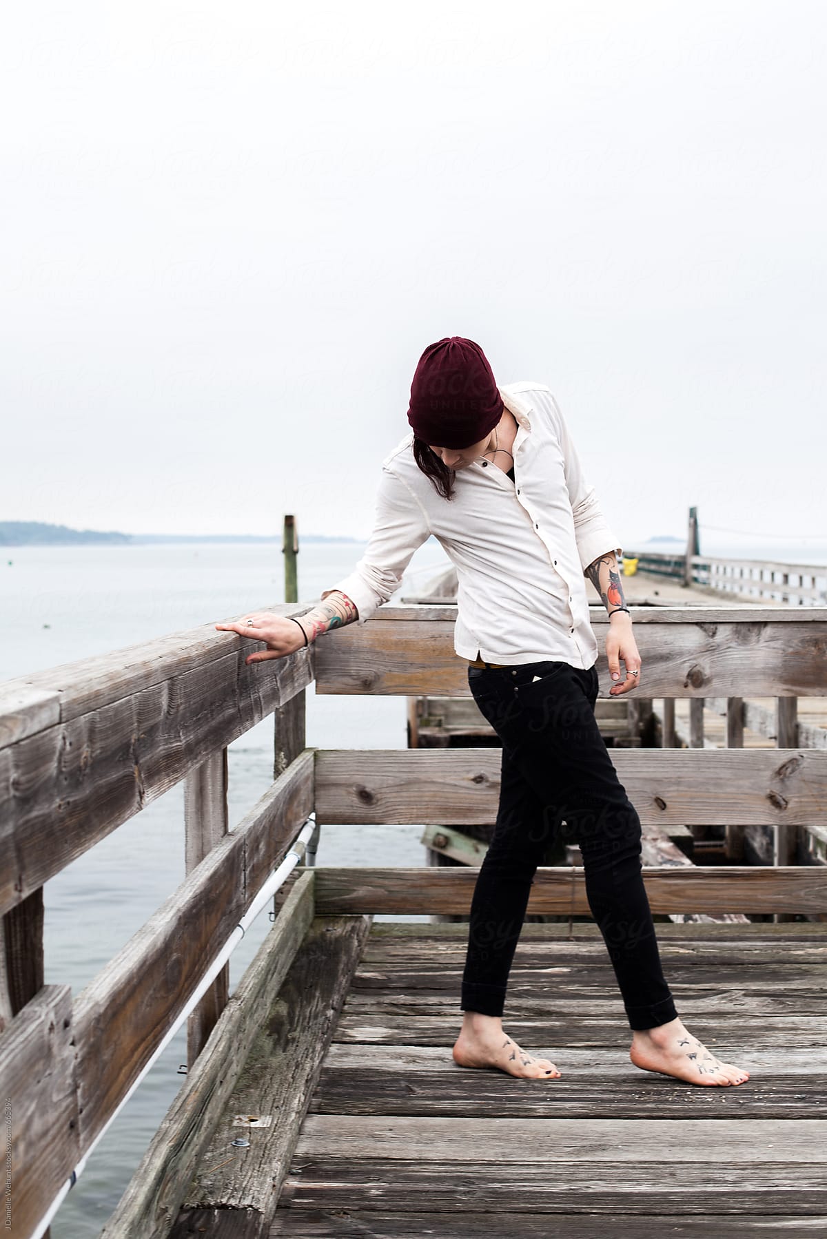 Portrait of a gender neutral, gender fluid person person standing on pier