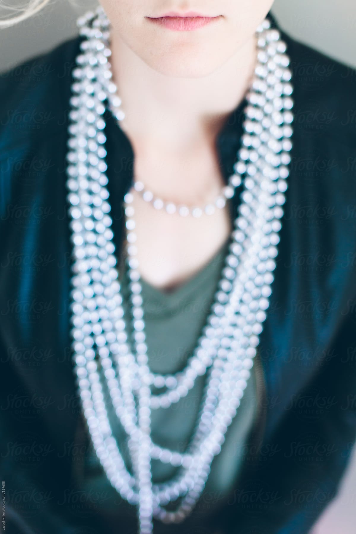 Girl wearing a long string of beads around her neck