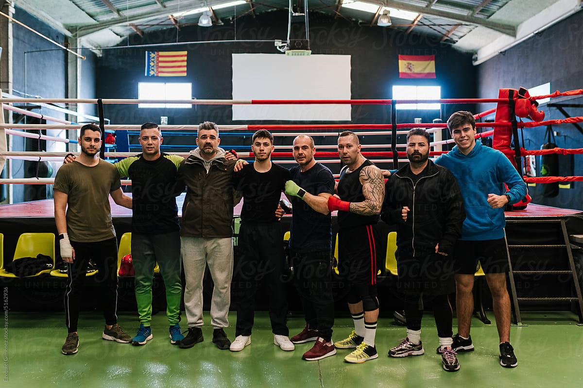 Group of sportspeople standing in boxing gym