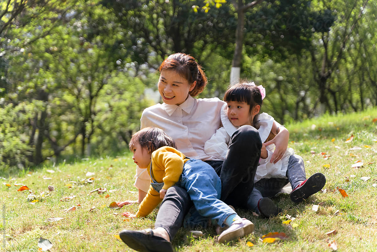 Happy Asian Kids Playing Outdoor In The Park by Stocksy Contributor Bo  Bo - Stocksy