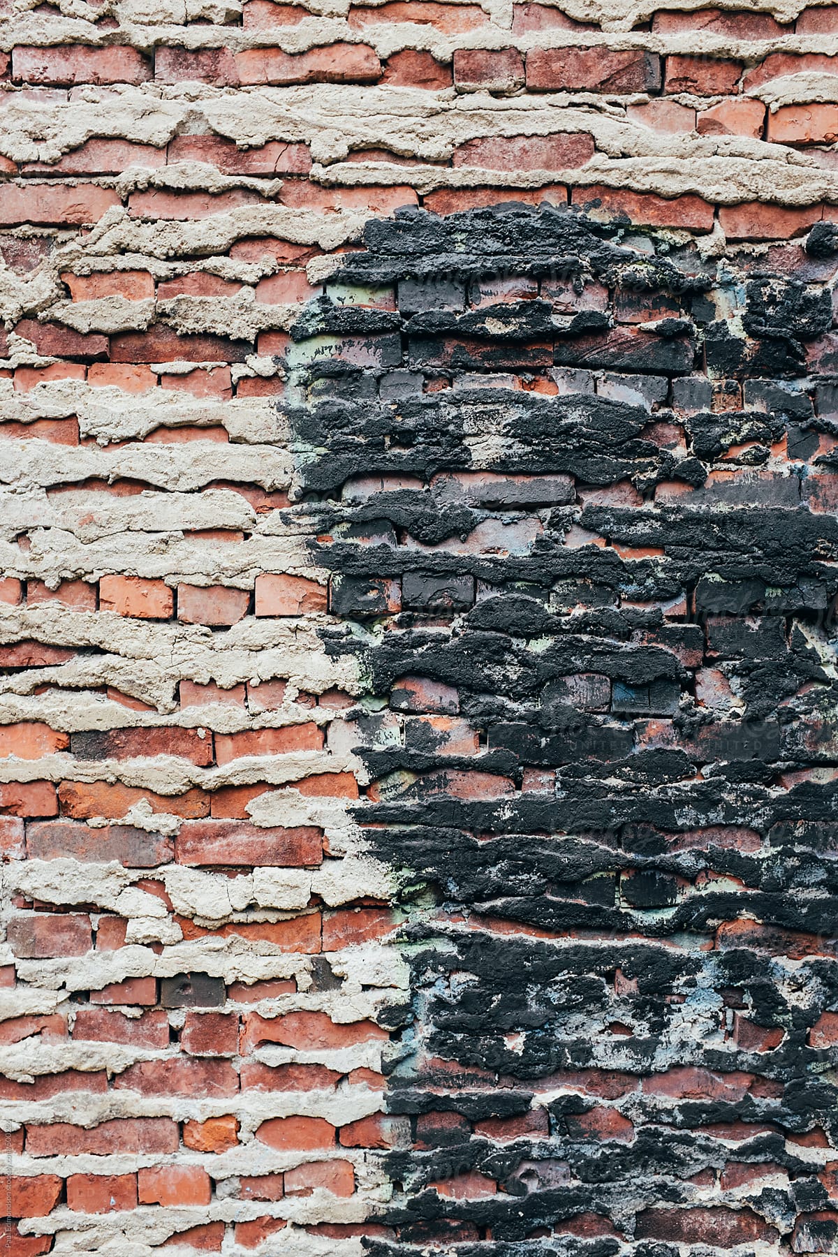 Detail of old brick wall and black paint