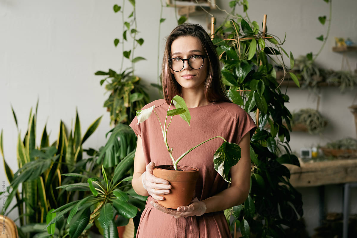 Portrait Of Girl Holding Plant