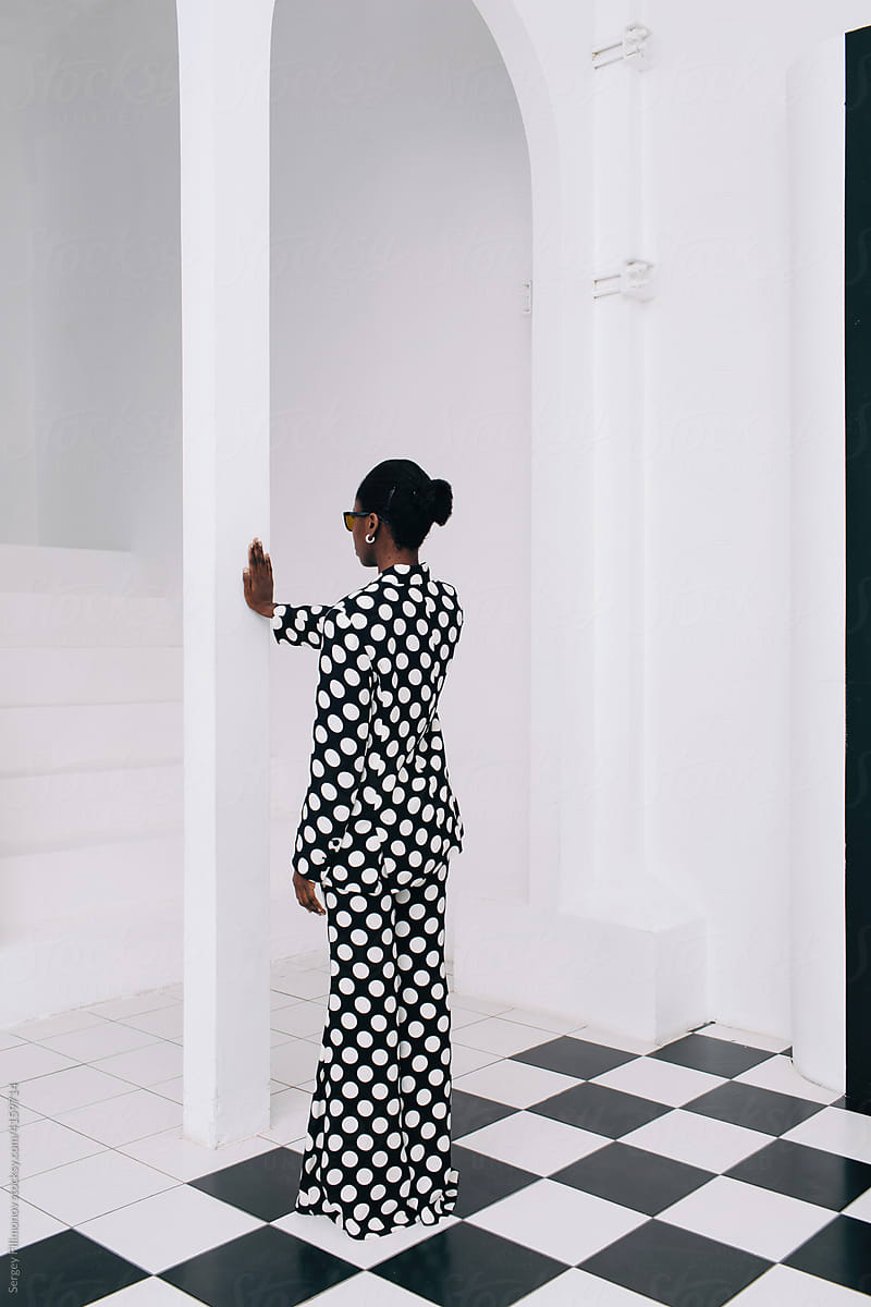 Anonymous black woman fashion white interior